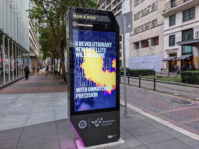 A digital ad display on a sidewalk