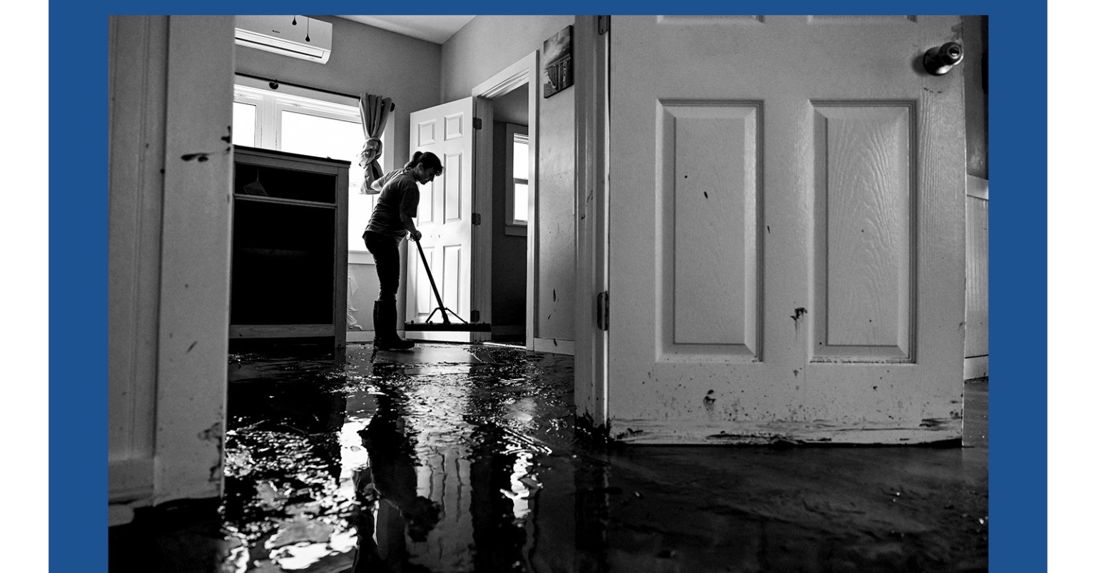 A woman cleaning her house after Hurricane Helene made landfall in Cedar Key, Florida.