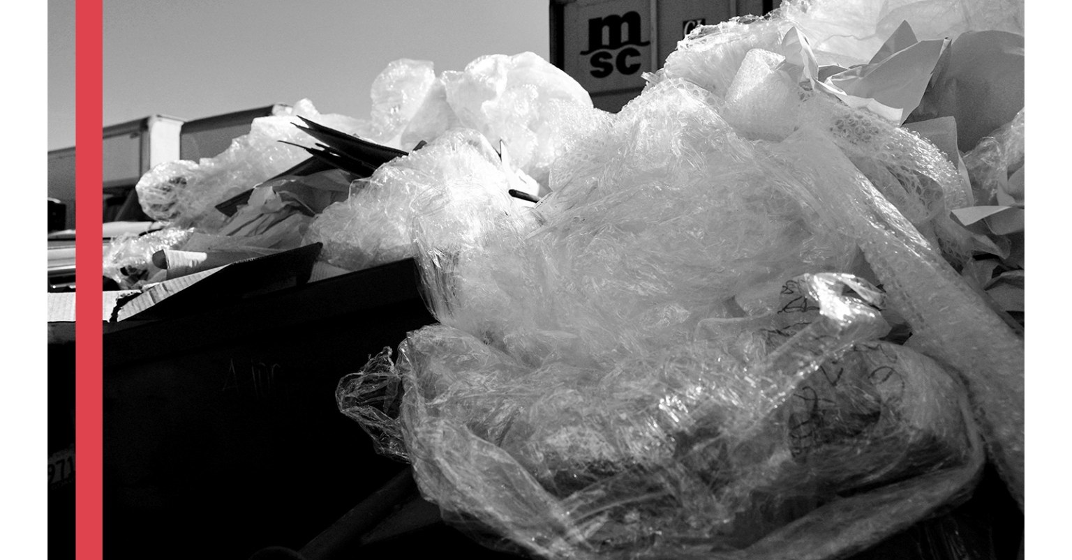 A black and white photo of a large plastic bag of garbage. The collage has a red vertical stripe to the side of the image.