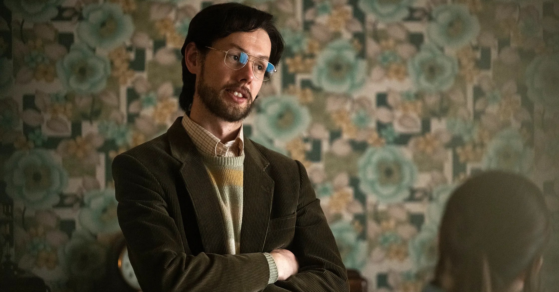 A young man in glasses and a blazer