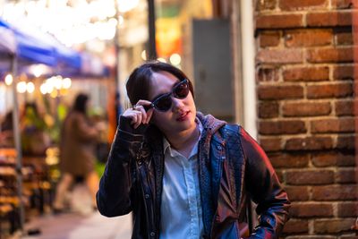 A person wearing Ray-Ban Meta Smart Glasses on a busy street.