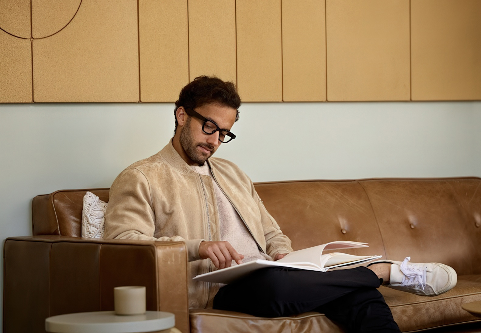 A tech bro wearing a prototype of Android XR glasses in a modern posh office.