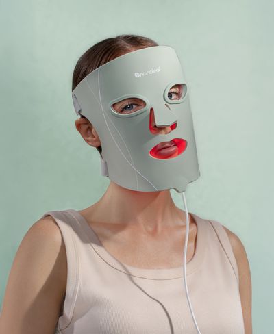 WOman giving a coy look in Nanoleaf’s LED Light Therapy Face Mask.