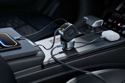 The Baseus PrimeTrip VR2 Max car charger used inside a vehicle with several devices connected.