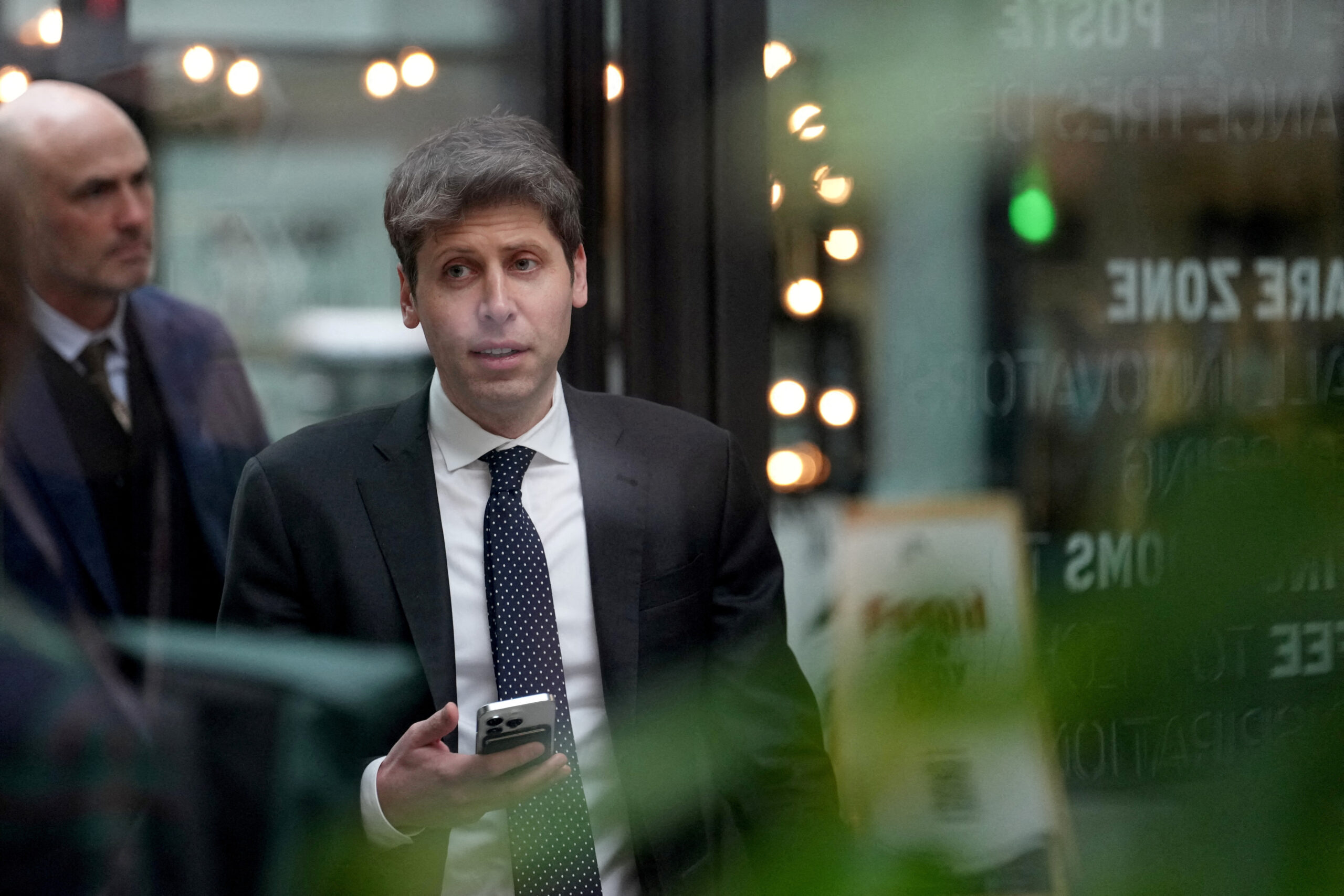 Sam Altman, CEO of OpenAI, at Station F, is seen through glass, during an event on the sidelines of the Artificial Intelligence Action Summit in Paris, France, Feb. 11, 2025.     Aurelien Morissard/Pool via REUTERS