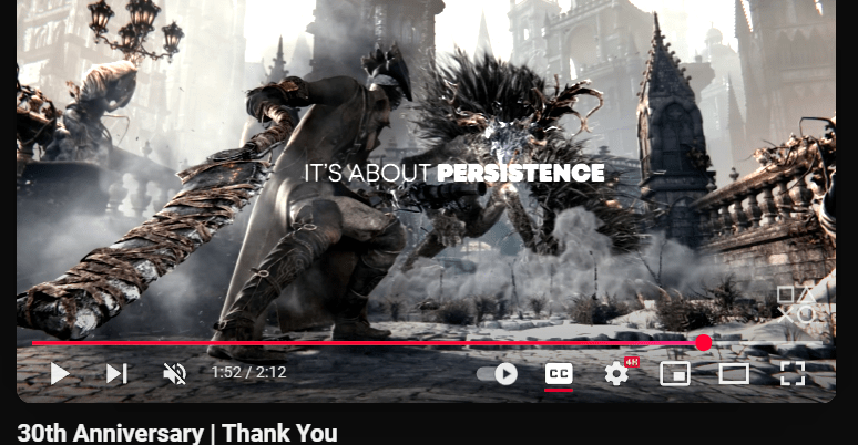 “It’s about persistence” displays over video of Bloodborne’s main character fighting with a jagged cleaver like sword.