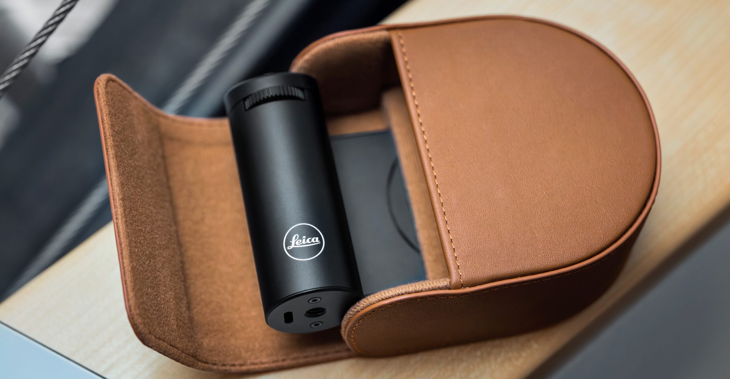 The Leica Lux Grip accessory inside a leather case.