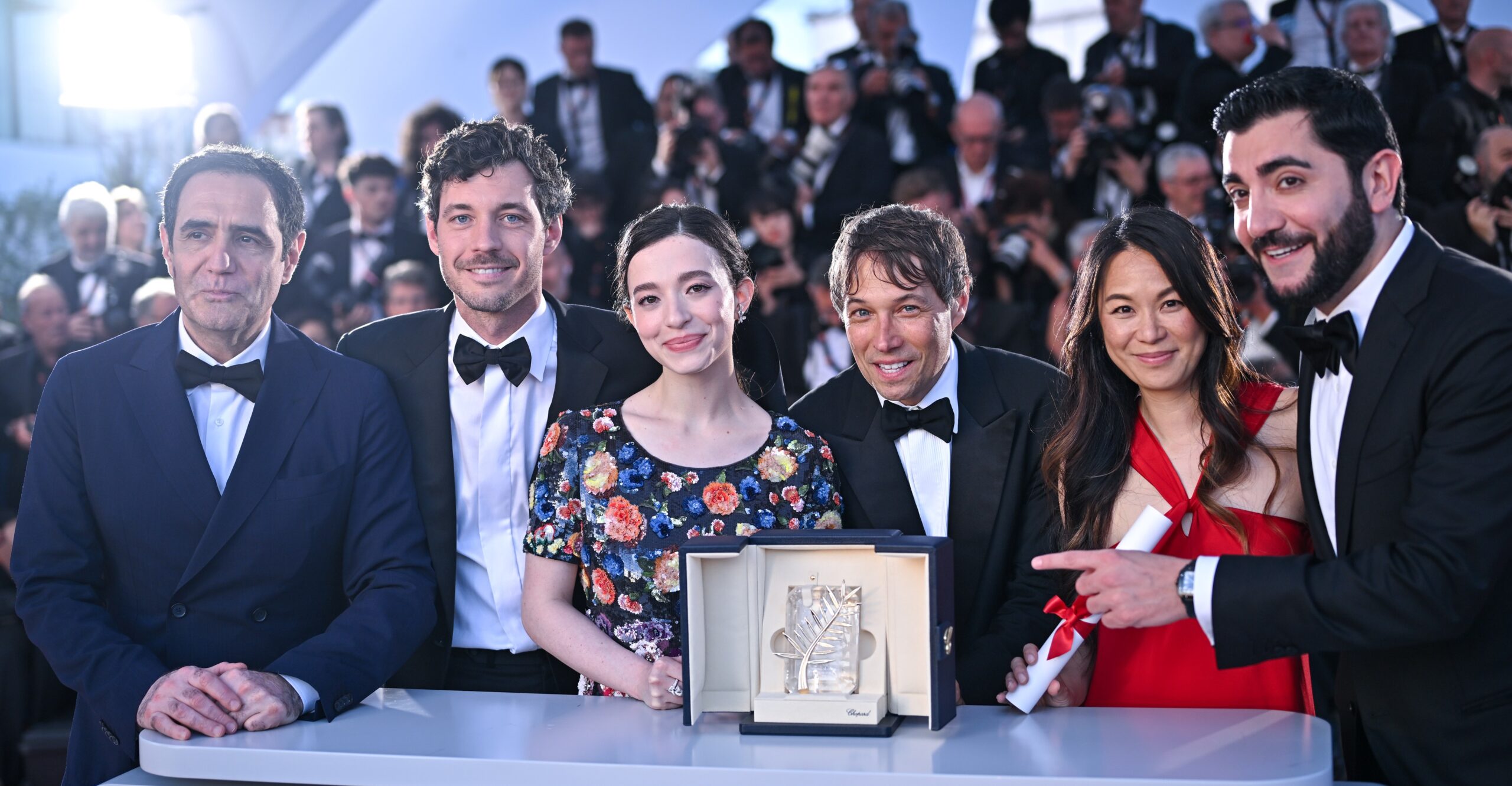 Karren Karagulian, Alex Coco, Mikey Madison, Sean Baker, Samantha Quan and Vache Tovmasyan pose with the 'Palme d'Or' Award for Anora during the Closing Ceremony at the 77th annual Cannes Film Festival at Palais des Festivals on May 25, 2024 in Cannes, France. 