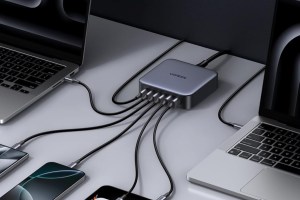 Ugreen's Nexode Charger (200W, 6-Port) connected to two MacBooks and other devices.