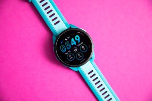 Garmin Forerunner 165 Music on a bright pink background.