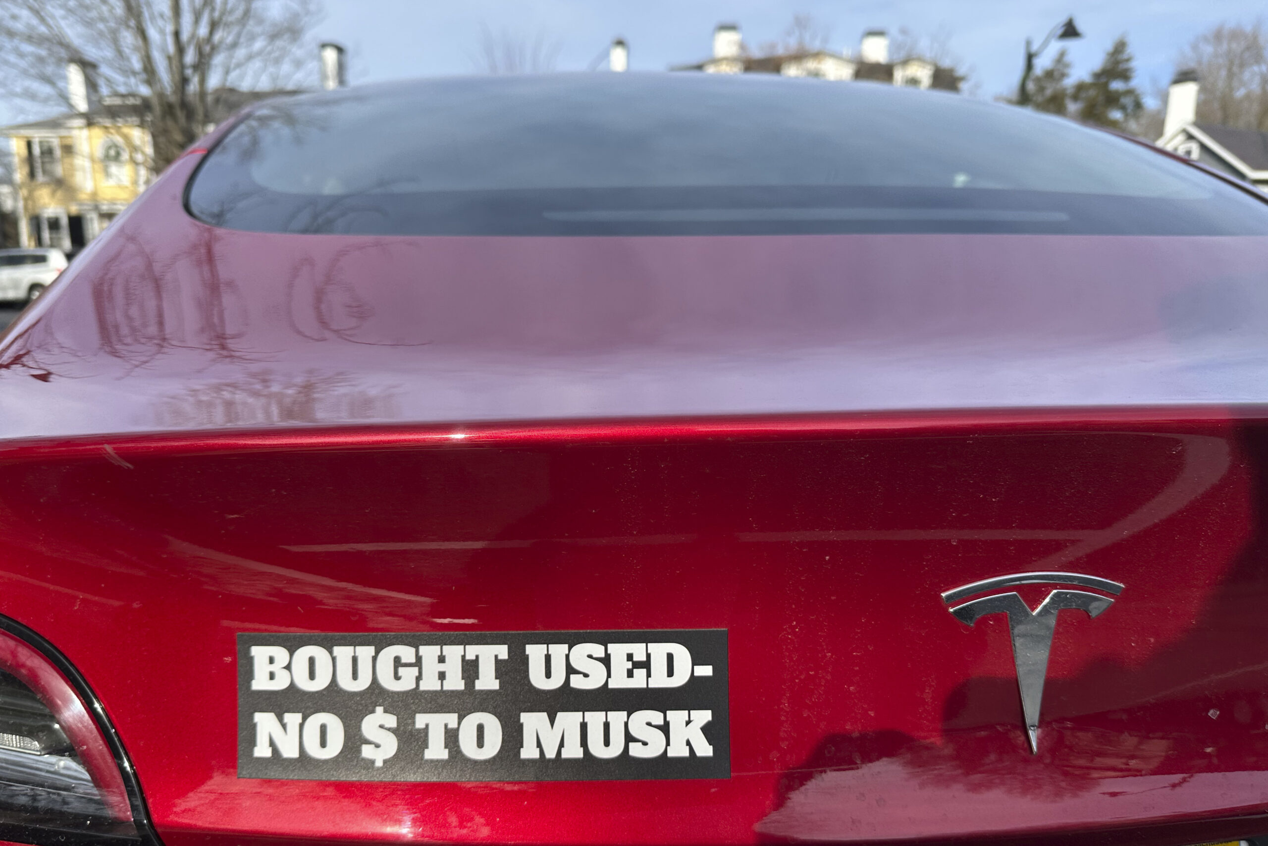 A Tesla with a sticker referring to the car's purchase is shown on Sunday, Dec. 15, 2024 in Concord, Mass.. (AP Photo/Peter Morgan)