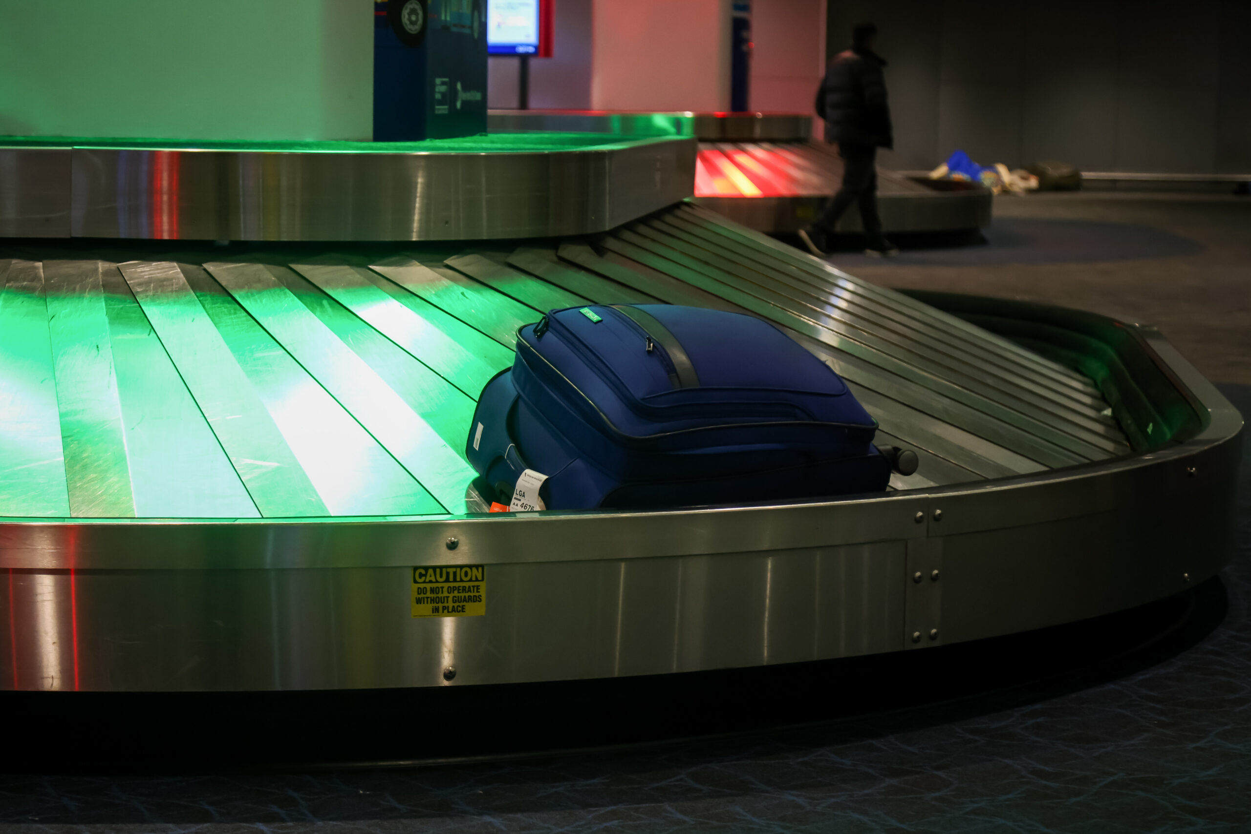 A suitcase sits on a conveyor belt