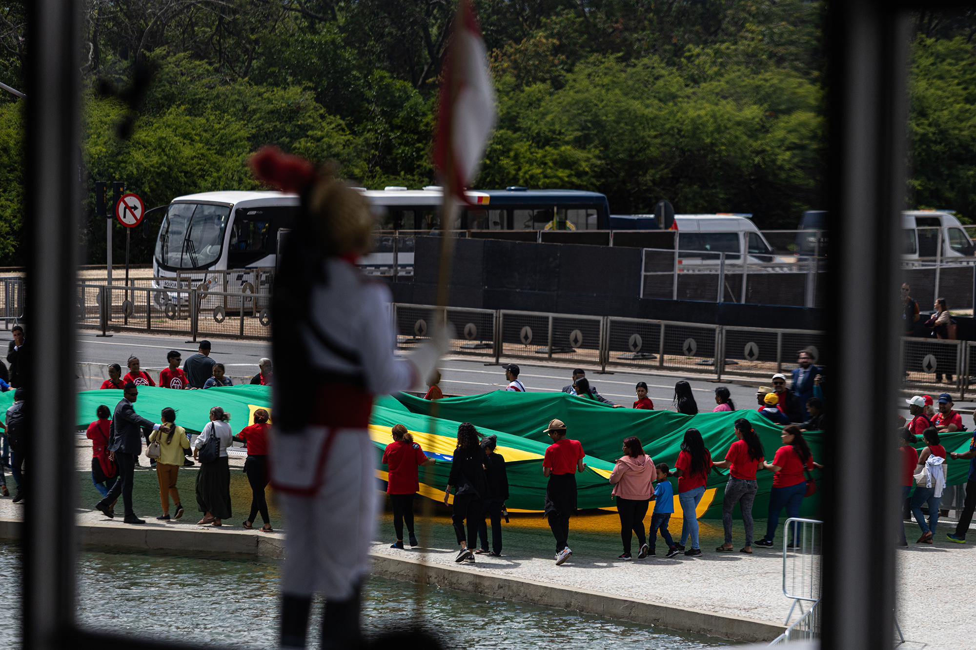People unfurling a large Brazilian flag