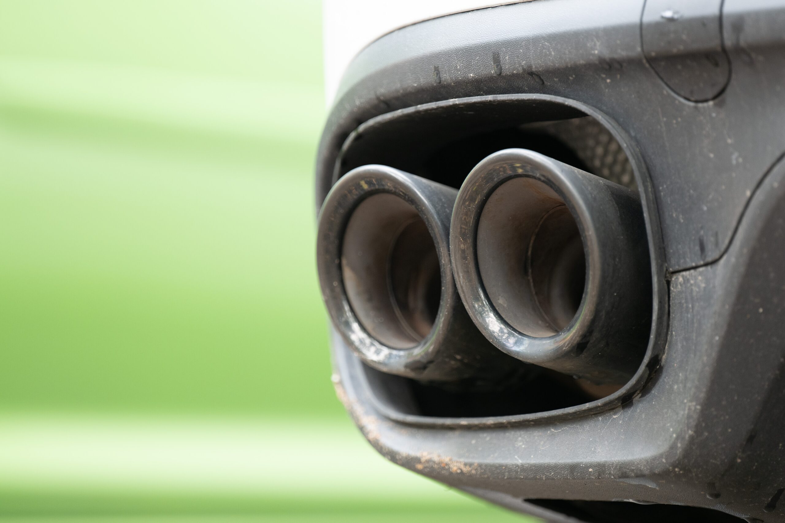 Exhaust pipes of a vehicle in a parking lot.