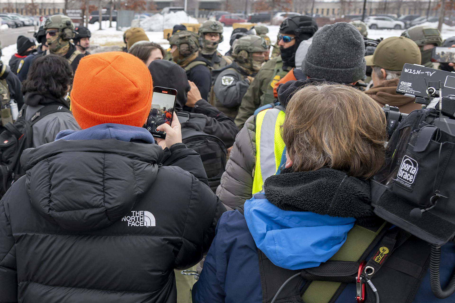 Protesters film ICE agents on with smartphones and cameras