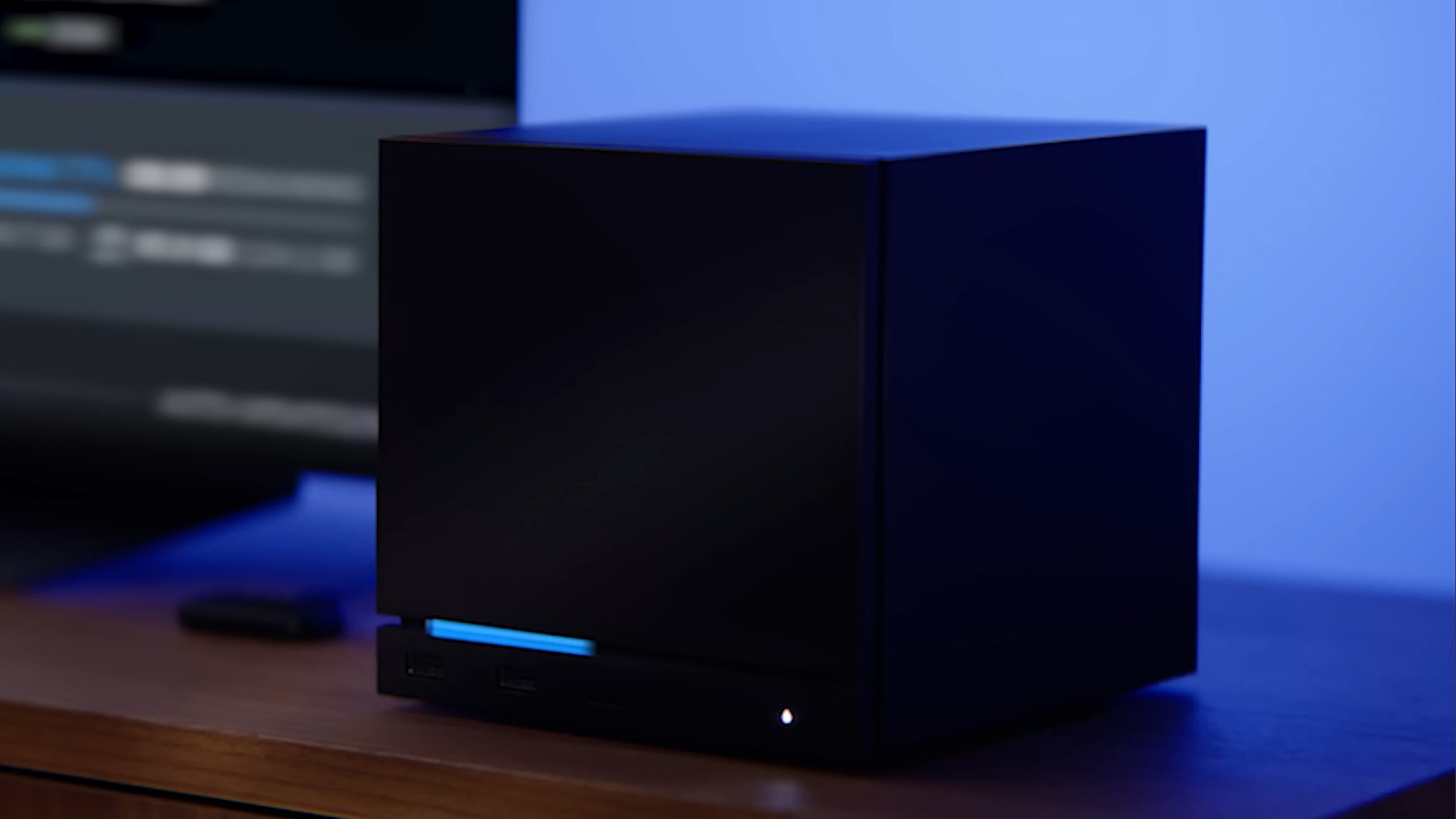 A Steam Machine with an LED strip displaying the current download progress of a game.