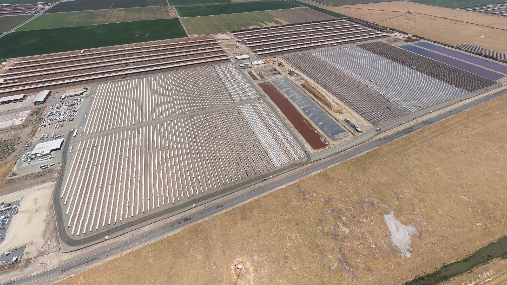 an aerial view of a massive dairy farm with rows of tightly-packed calves an aerial view of a massive dairy farm with rows of tightly-packed calves