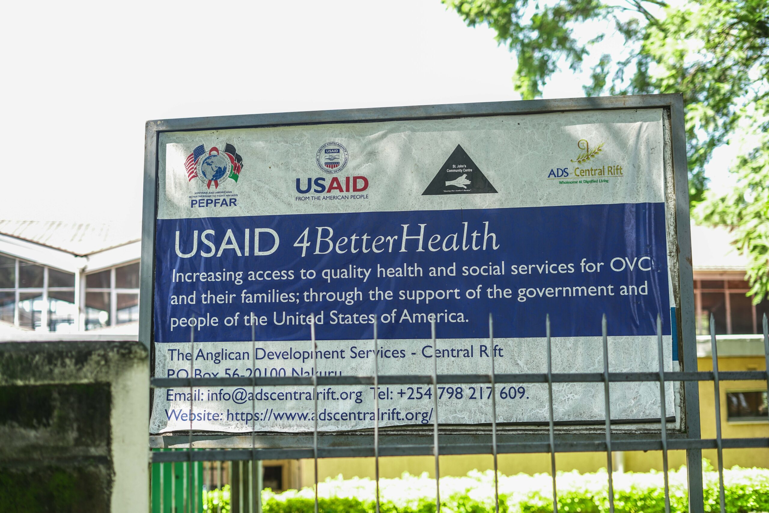 A billboard inside a church compound with information about the suspended USAID program