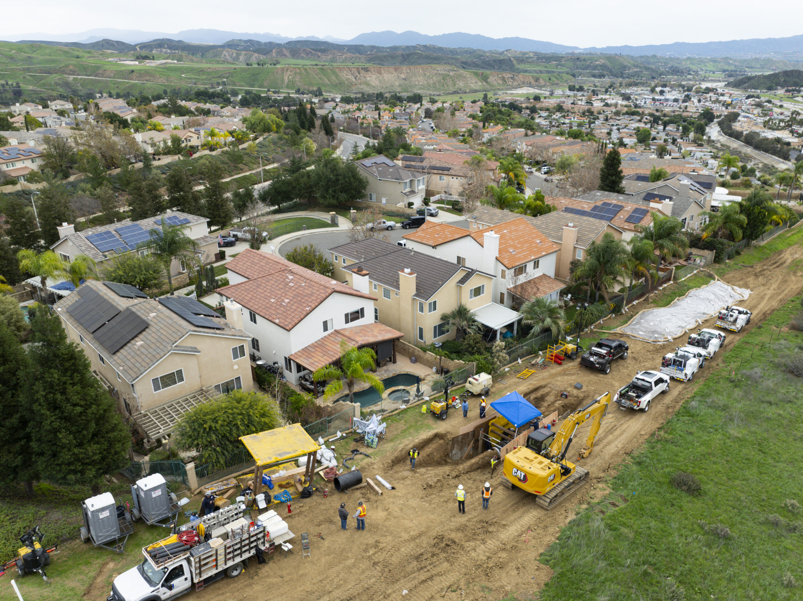 Aerial shot of a densely populated California neighborhood, where a gas crew is repairing a natural gas line. Aerial shot of a densely populated California neighborhood, where a gas crew is repairing a natural gas line.