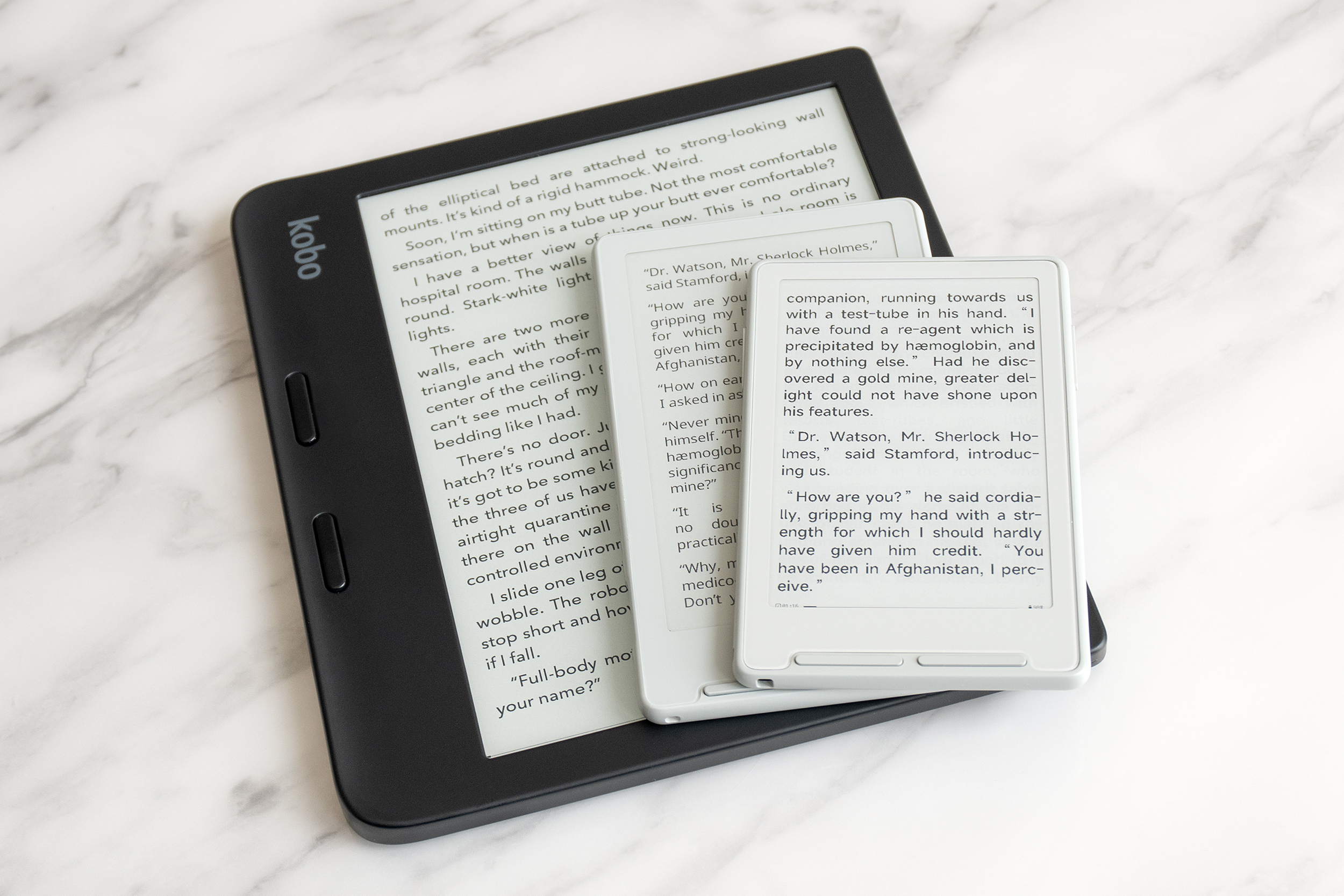 The Xteink X3 e-reader stacked atop the X4 and a Kobo Libra 2.