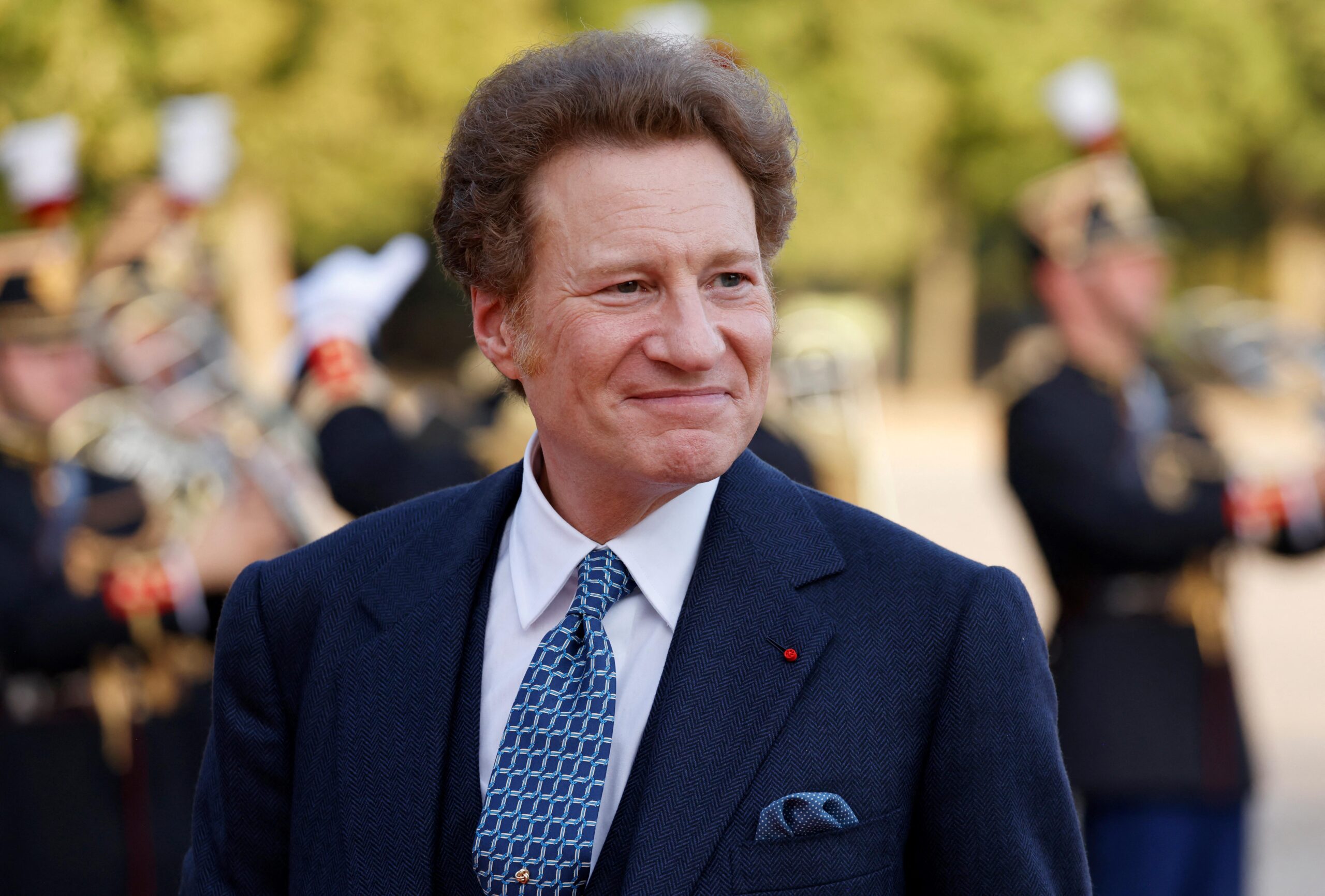 Thomas Kaplan, a middle-aged man in a blue suit.