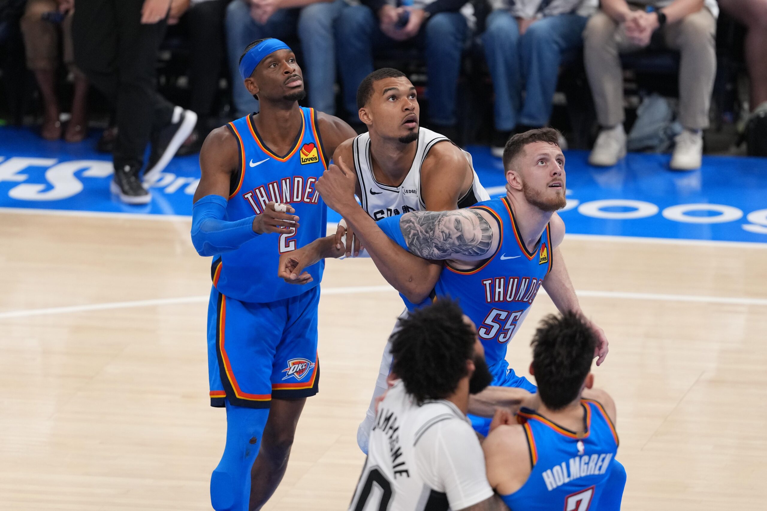 Shai Gilgeous-Alexander and Isaiah Hartenstein battle for a rebound against Victor Wembanyama Shai Gilgeous-Alexander and Isaiah Hartenstein battle for a rebound against Victor Wembanyama