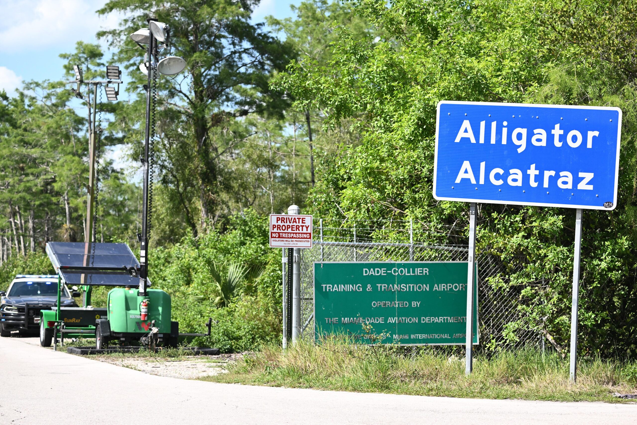 A Florida Highway Patrol car is seen at the entrance to the immigrant detention center known as "Alligator Alcatraz" 