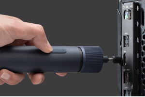 Someone using the Hoto 3.6V electric screwdriver to work on a computer.