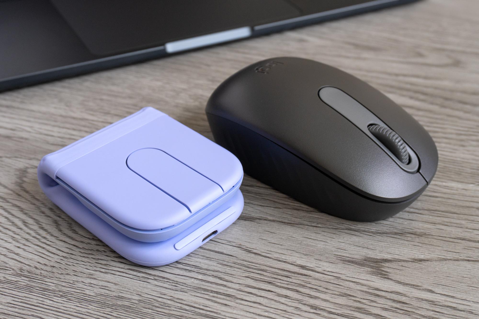 The Logitech Mobi Fold mouse next to another compact Logitech mouse featuring a scroll wheel. 