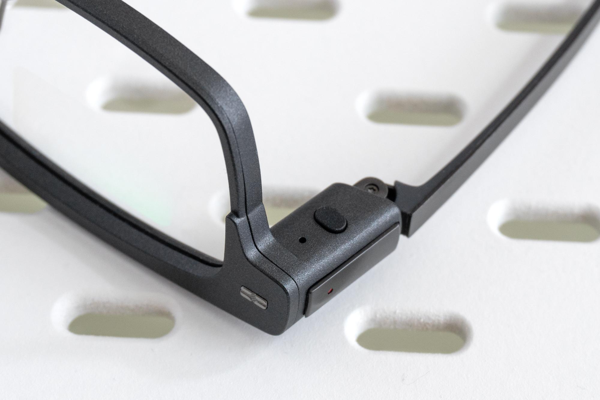 A close-up of the single button on the right side of the Xgimi MemoMind One smart glasses.