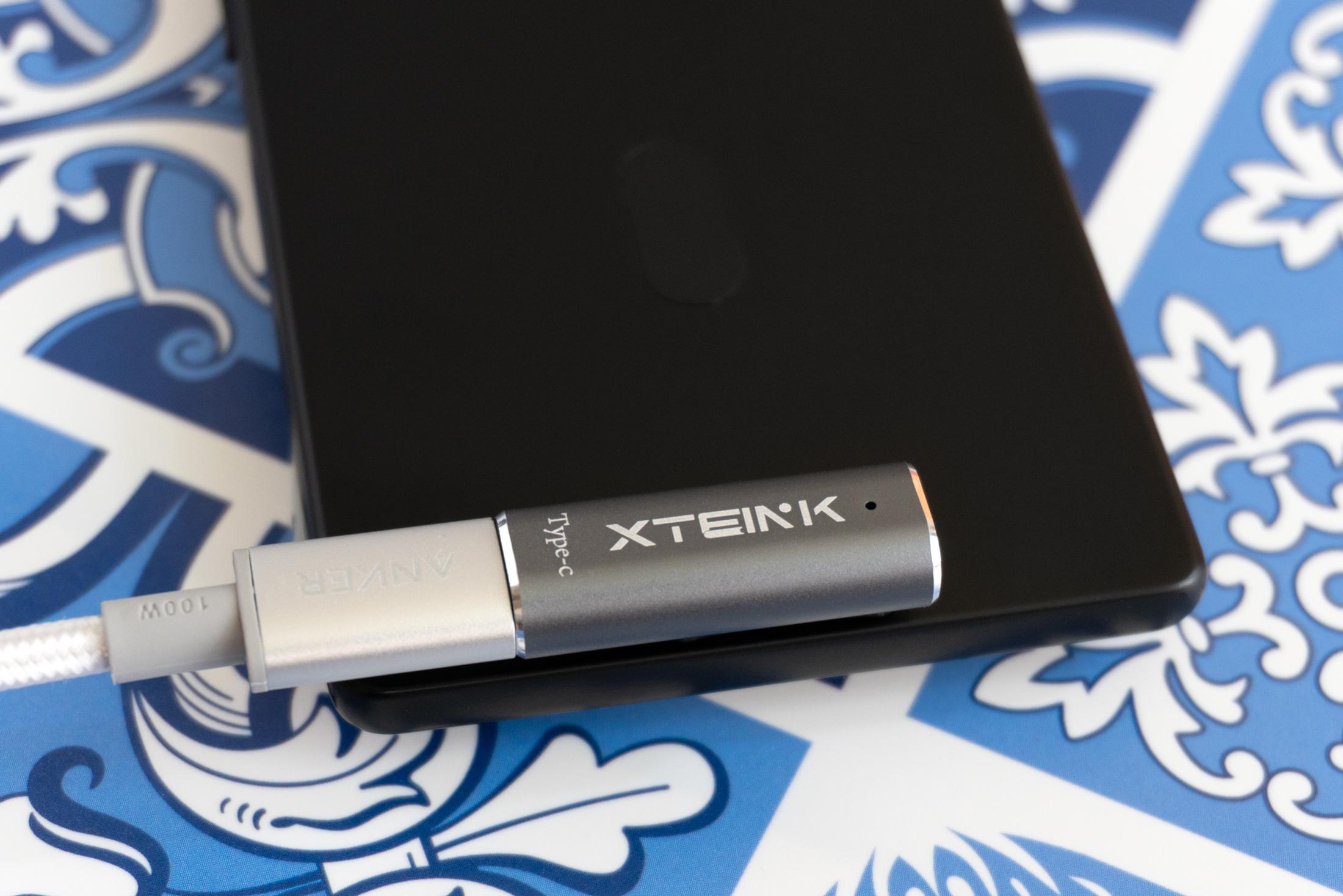 A close-up of a magnetic pogo-pin charger attached to the back of the Xteink X4 Pro. A close-up of a magnetic pogo-pin charger attached to the back of the Xteink X4 Pro.