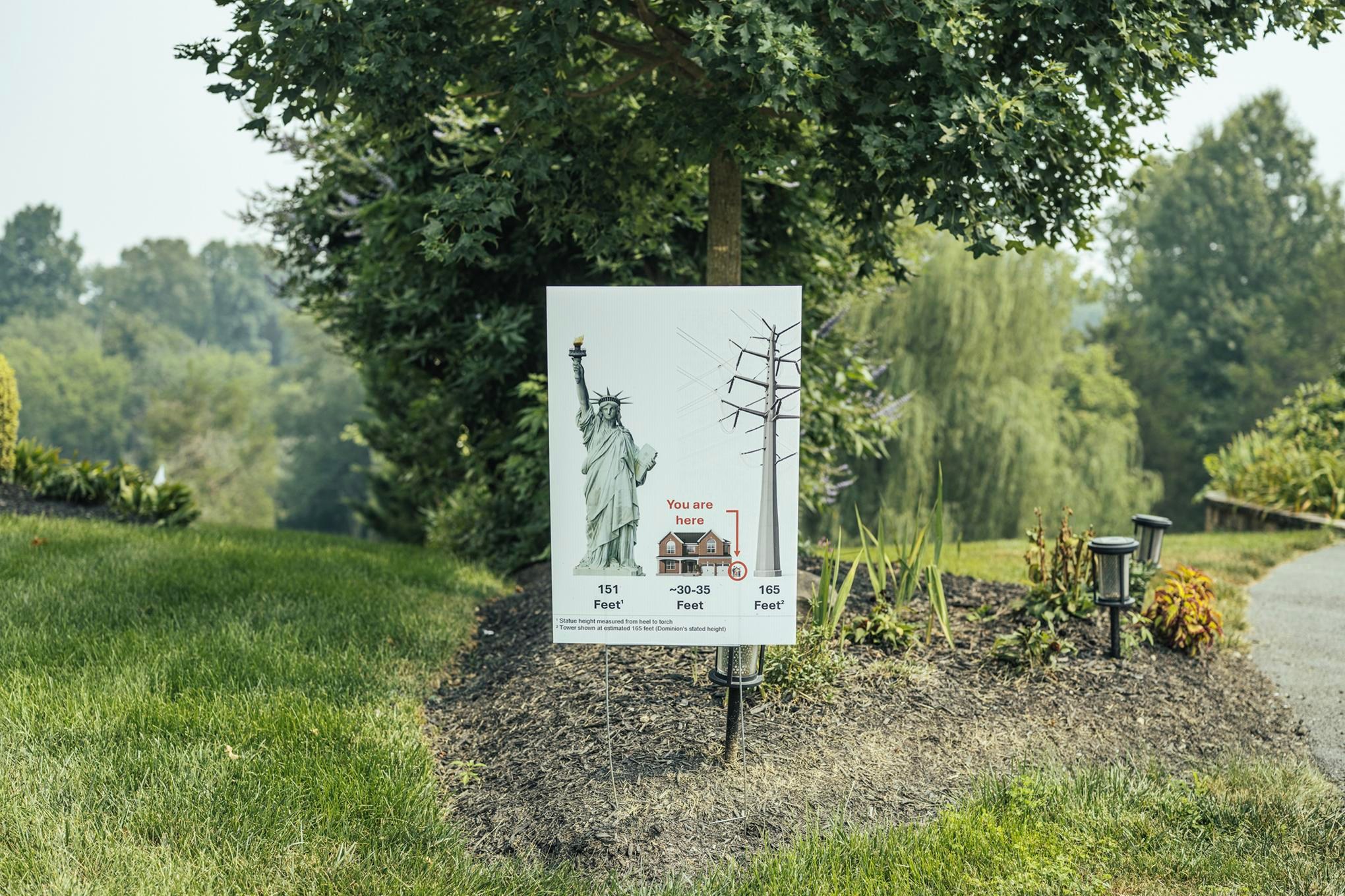 A sign in Loudoun Valley Estates compares the size of a proposed transmission tower to the Statue of Liberty.