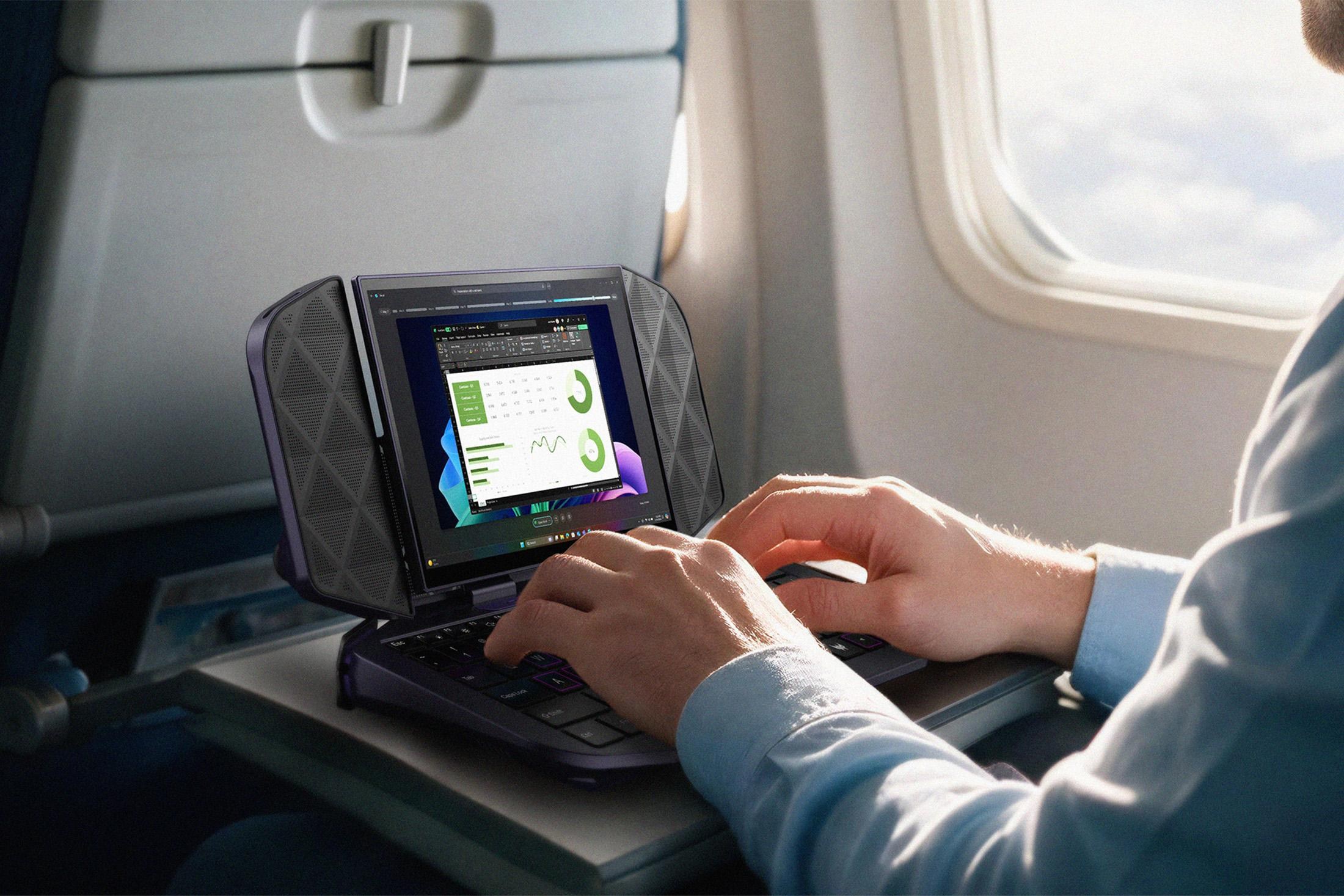 A person on a plane types on the Acer Project DualPlay Mini Concept's tiny keyboard.