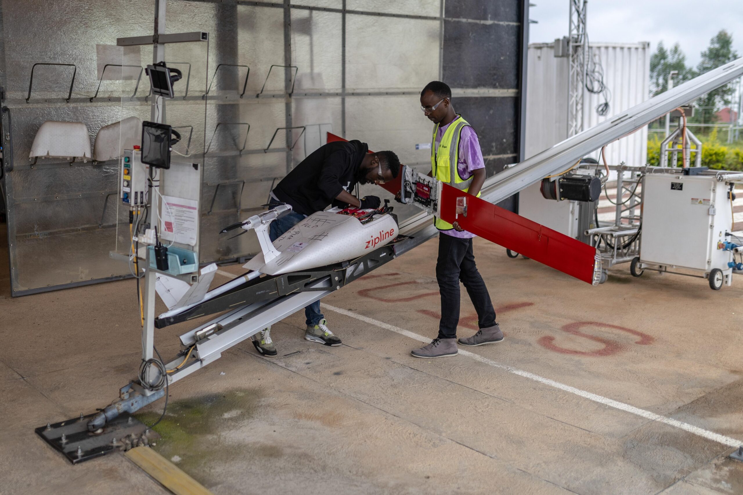 Employees assemble a blood delivery drone before its launch at a Zipline drone nest launching site near Kigali, Rwanda, on Thursday, April 4, 2024. Zipline, a drone medical delivery service first developed in Rwanda and Ghana, now primarily operates in the US in partnership with Novant Health and customers including Walmart. Photographer: Guillem Sartorio/Bloomberg via Getty Images