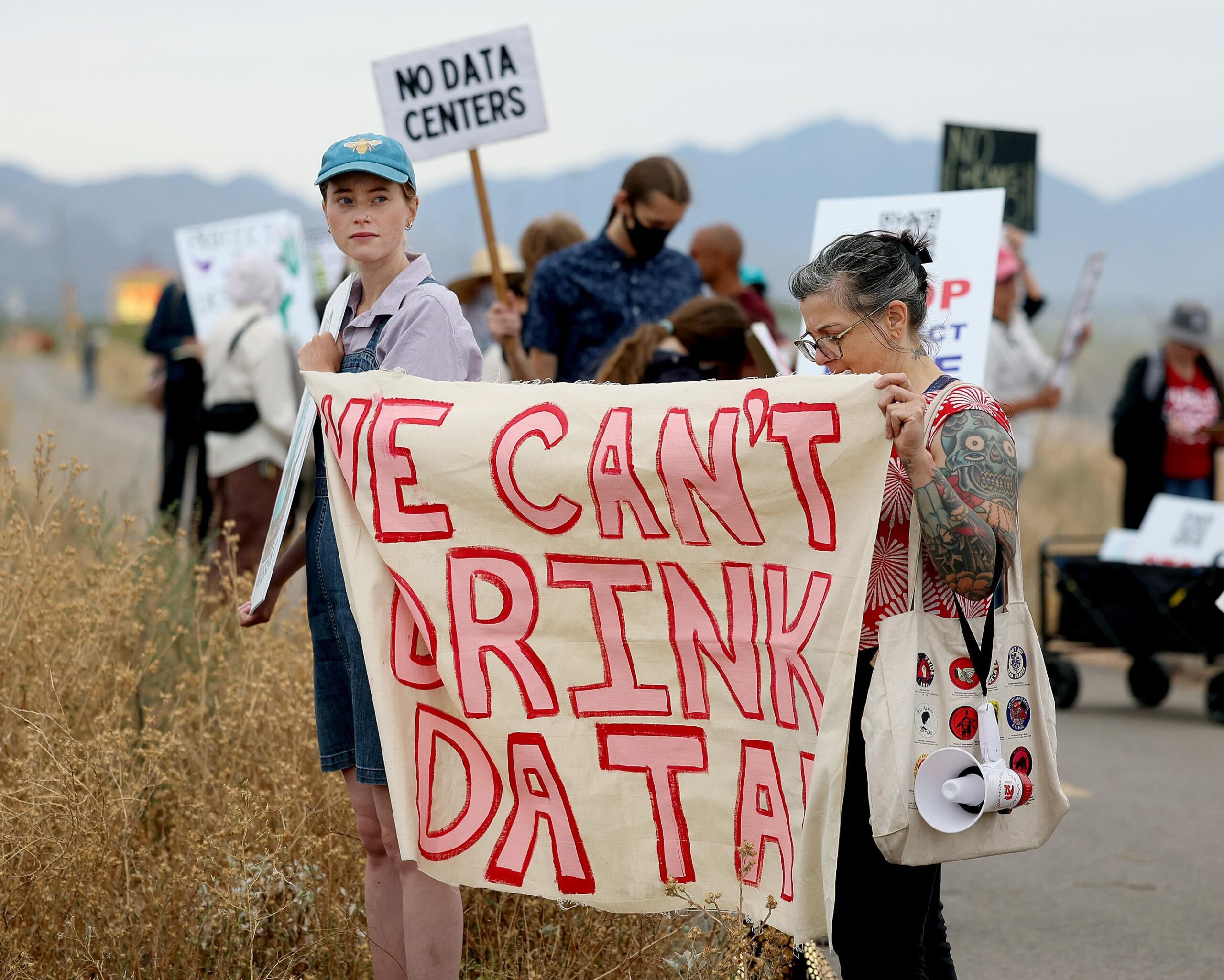 Demonstrators hold signs during a protest against the Project Blue data center near the construction site at S. Houghton Road and E. Brekke Road in Tucson, Ariz. on May 28, 2026. Beale Infrastructure, the company behind Project Blue, was approved for permits to drill two wells on the property. (Mamta Popat/Arizona Daily Star via Getty Images) Demonstrators hold signs during a protest against the Project Blue data center near the construction site at S. Houghton Road and E. Brekke Road in Tucson, Ariz. on May 28, 2026. Beale Infrastructure, the company behind Project Blue, was approved for permits to drill two wells on the property. (Mamta Popat/Arizona Daily Star via Getty Images)