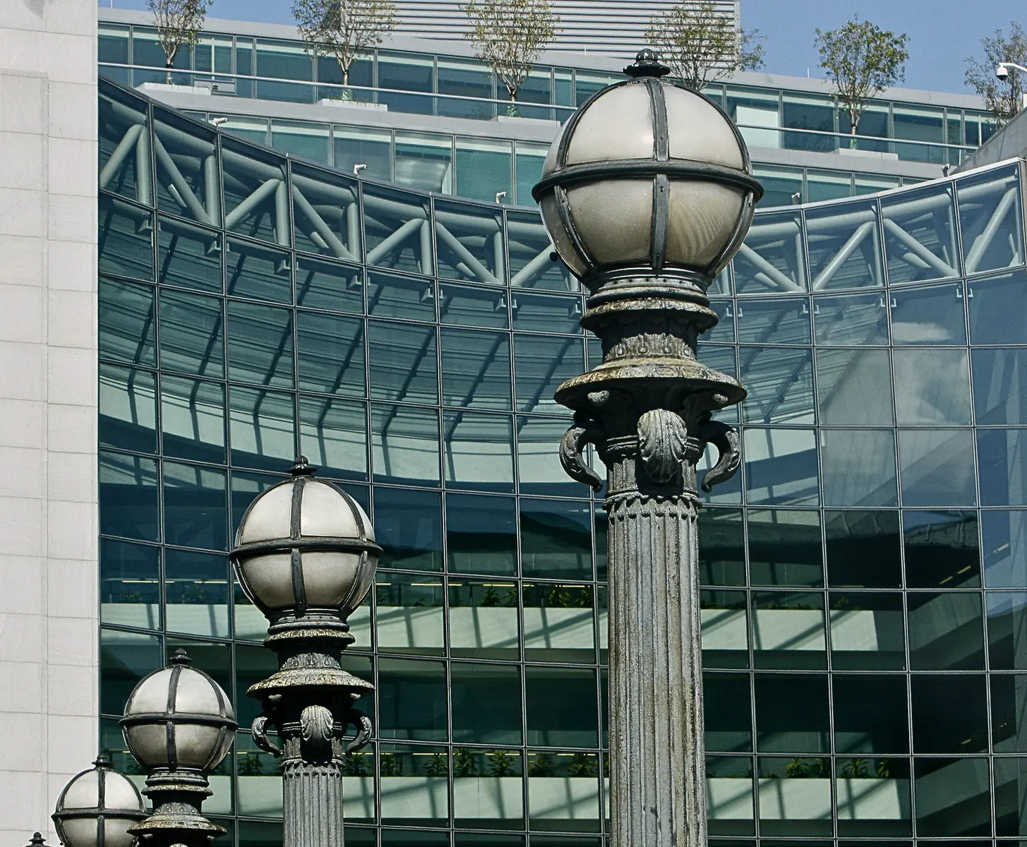 Ornate street lamps in the foreground with the glass facade of the SEC headquarters in the background.