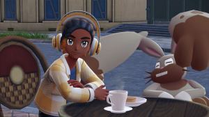 A Pokémon Legends: Z-A screenshot depicting a trainer and a Diggersby sitting at a table in front of a cafe.